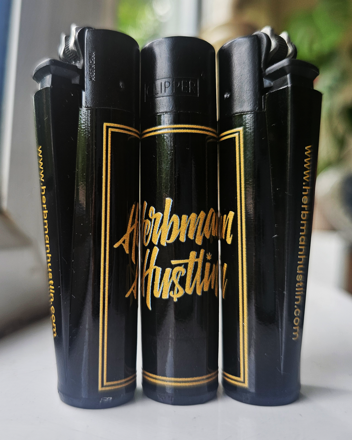 Herbman Hustlin Script Clipper Lighter - Black/Gold
